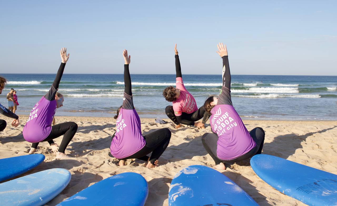 The group warming up beside their surfboards